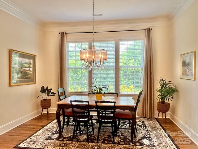 1025 N Sharon Amity Rd, Charlotte, NC 28211 - dining room featuring crown molding, baseboards, a chandelier, and dark wood-type flooring