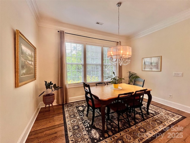 1025 N Sharon Amity Rd, Charlotte, NC 28211 - dining area with crown molding, dark wood-type flooring, a chandelier, and baseboards