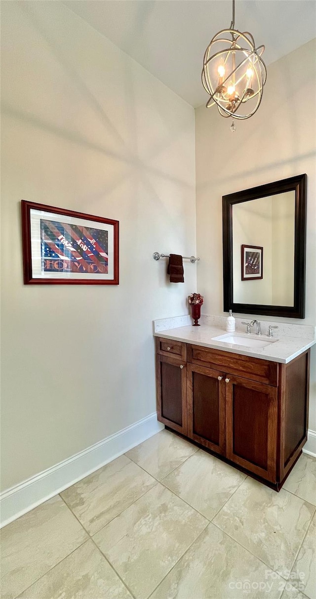 1025 N Sharon Amity Rd, Charlotte, NC 28211 - bathroom featuring a chandelier, vanity, baseboards, and marble look tile flooring