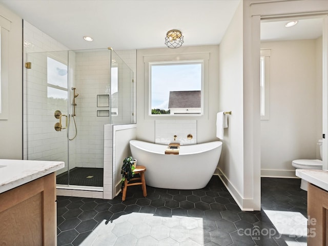 1172 Springlake Rd, York, SC 29745 - full bathroom featuring vanity, a stall shower, a freestanding bath, toilet, and recessed lighting