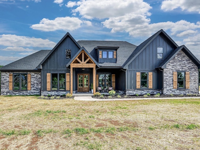 1172 Springlake Rd, York, SC 29745 - modern farmhouse featuring board and batten siding, roof with shingles, stone siding, and a front lawn