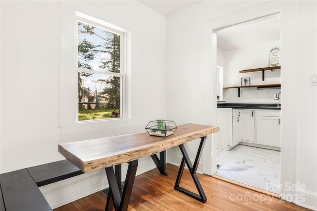 17 Springdale Ave, Asheville, NC 28803 - dining room featuring healthy amount of natural light, light marble finish floors, and baseboards