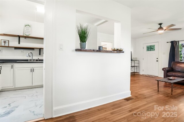 17 Springdale Ave, Asheville, NC 28803 - corridor featuring a sink, baseboards, and light wood-type flooring
