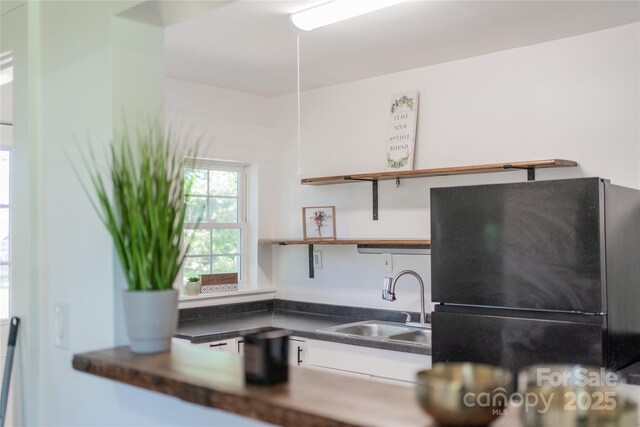 17 Springdale Ave, Asheville, NC 28803 - kitchen featuring a sink, freestanding refrigerator, open shelves, dark countertops, and white cabinets