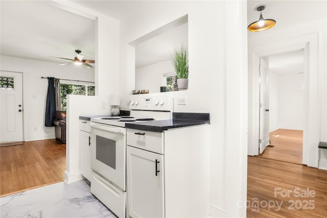 17 Springdale Ave, Asheville, NC 28803 - kitchen with white electric stove, ceiling fan, white cabinetry, dark countertops, and light wood finished floors