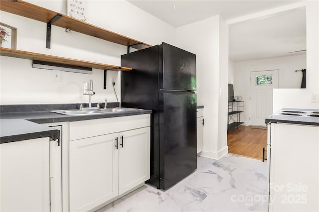 17 Springdale Ave, Asheville, NC 28803 - kitchen with open shelves, freestanding refrigerator, dark countertops, and light marble finish floors
