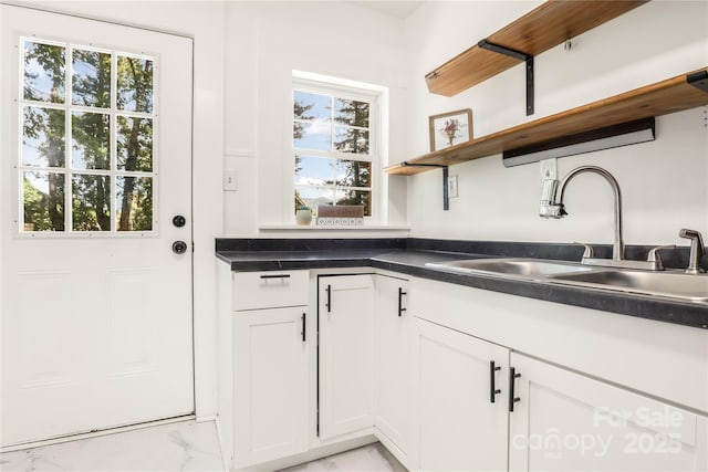 17 Springdale Ave, Asheville, NC 28803 - kitchen with a sink, light marble finish flooring, open shelves, dark countertops, and white cabinets