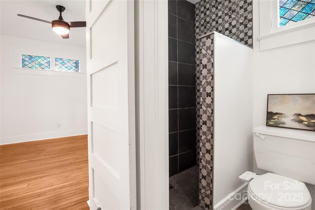 17 Springdale Ave, Asheville, NC 28803 - bathroom with a stall shower, wood finished floors, baseboards, toilet, and ceiling fan