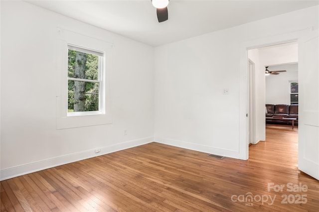 17 Springdale Ave, Asheville, NC 28803 - spare room with a ceiling fan, wood-type flooring, and baseboards