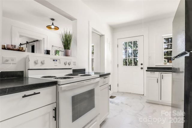 17 Springdale Ave, Asheville, NC 28803 - kitchen featuring white electric stove, light marble finish floors, freestanding refrigerator, and dark countertops