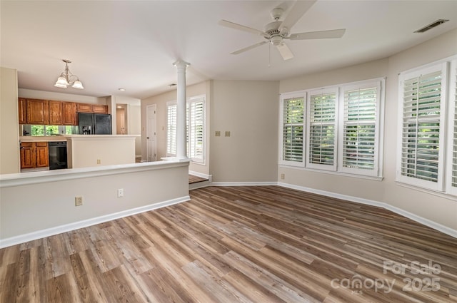 302 NW Dr, Davidson, NC 28036 - unfurnished living room featuring decorative columns, wood finished floors, and a ceiling fan