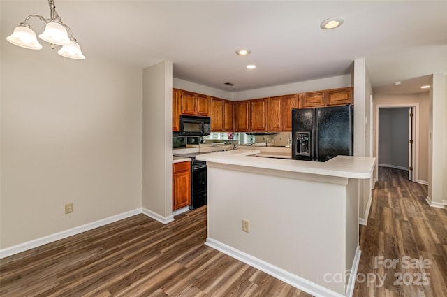 302 NW Dr, Davidson, NC 28036 - kitchen featuring black appliances, dark wood-type flooring, light countertops, a chandelier, and recessed lighting