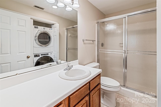 302 NW Dr, Davidson, NC 28036 - full bath with stacked washer and clothes dryer, a shower with door, vanity, and tile patterned flooring