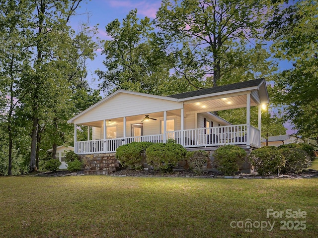 17835 Terryglass Ln, Charlotte, NC 28278 - farmhouse with covered porch, a front lawn, and a ceiling fan
