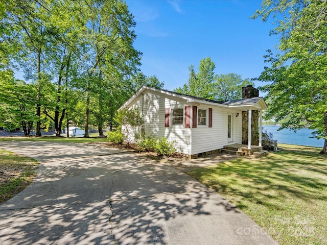 17835 Terryglass Ln, Charlotte, NC 28278 - view of front of house featuring a chimney, a front yard, and a water view