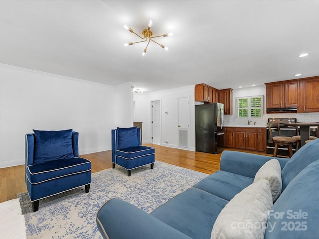 17835 Terryglass Ln, Charlotte, NC 28278 - living area featuring a chandelier, light wood-style flooring, recessed lighting, ornamental molding, and baseboards