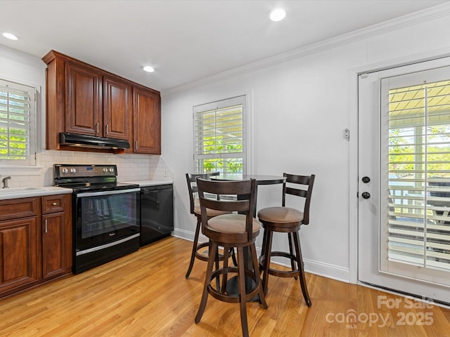 17835 Terryglass Ln, Charlotte, NC 28278 - kitchen featuring black appliances, ornamental molding, light wood finished floors, backsplash, and recessed lighting