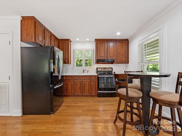 17835 Terryglass Ln, Charlotte, NC 28278 - kitchen with freestanding refrigerator, stainless steel range with electric cooktop, light wood finished floors, light countertops, and tasteful backsplash