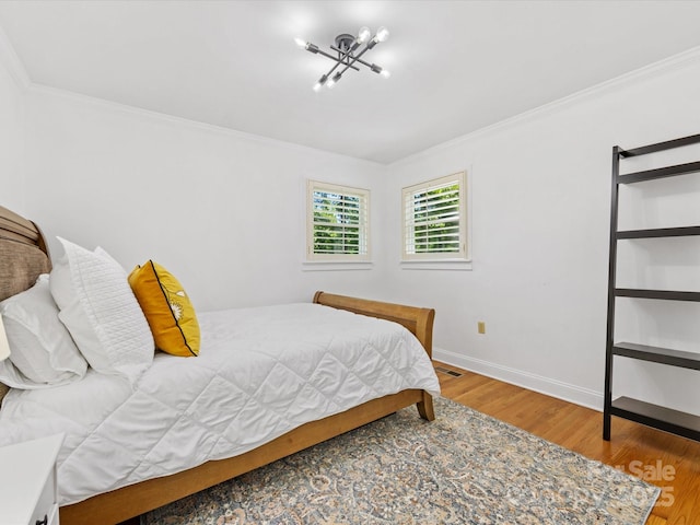 17835 Terryglass Ln, Charlotte, NC 28278 - bedroom with crown molding, wood finished floors, baseboards, and a chandelier