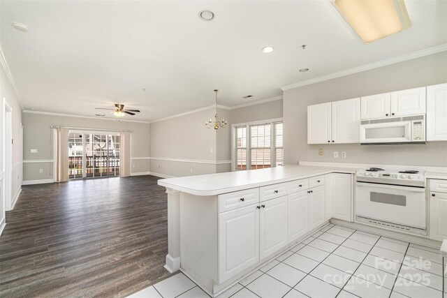 8969 Meadow Vista Rd, Charlotte, NC 28213 - kitchen with white appliances, ceiling fan, a peninsula, open floor plan, and a chandelier