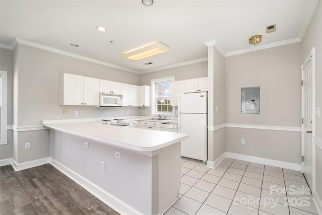 8969 Meadow Vista Rd, Charlotte, NC 28213 - kitchen featuring white appliances, electric panel, a peninsula, a sink, and light countertops