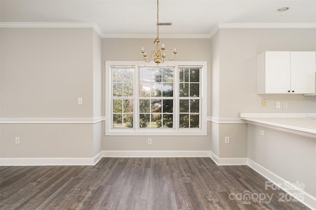 8969 Meadow Vista Rd, Charlotte, NC 28213 - unfurnished dining area featuring a chandelier, dark wood finished floors, baseboards, and ornamental molding