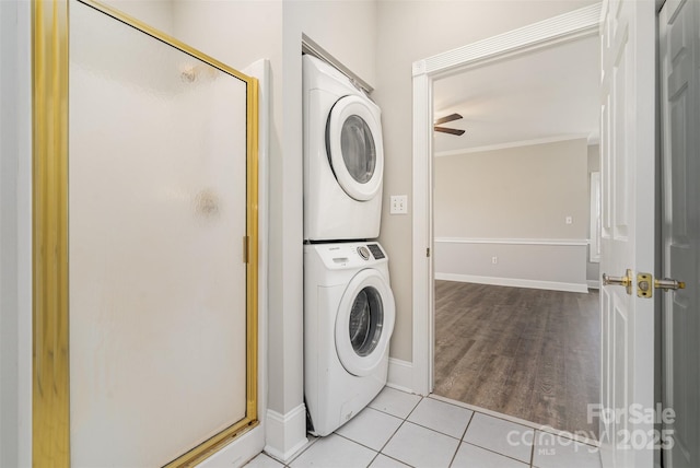 8969 Meadow Vista Rd, Charlotte, NC 28213 - washroom with stacked washing machine and dryer, crown molding, baseboards, tile patterned floors, and ceiling fan
