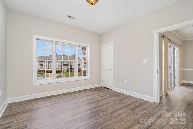 8969 Meadow Vista Rd, Charlotte, NC 28213 - empty room with healthy amount of natural light, wood finished floors, baseboards, and crown molding
