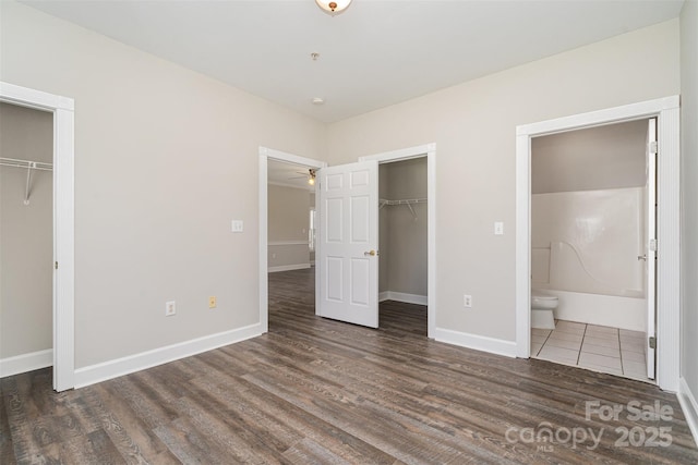 8969 Meadow Vista Rd, Charlotte, NC 28213 - unfurnished bedroom with a closet, a spacious closet, wood finished floors, baseboards, and ensuite bathroom