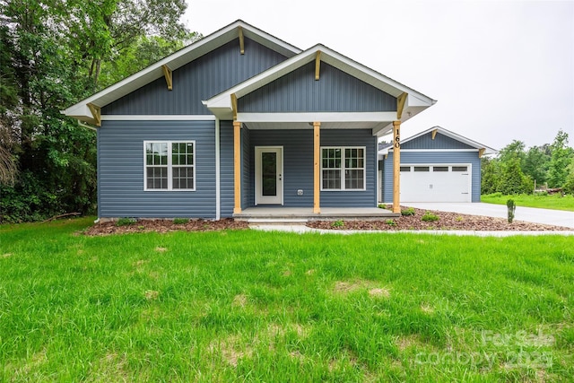 160 Wayne Gobble Rd, Linwood, NC 27299 - view of front of home with covered porch, driveway, a front lawn, and an attached garage