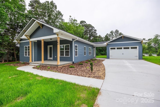 160 Wayne Gobble Rd, Linwood, NC 27299 - view of front of house with a porch, concrete driveway, a front yard, and a garage