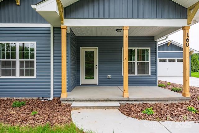 160 Wayne Gobble Rd, Linwood, NC 27299 - doorway to property with covered porch, board and batten siding, and a garage