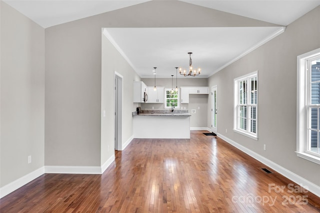 160 Wayne Gobble Rd, Linwood, NC 27299 - kitchen featuring a chandelier, white cabinets, dark wood-style floors, a peninsula, and crown molding