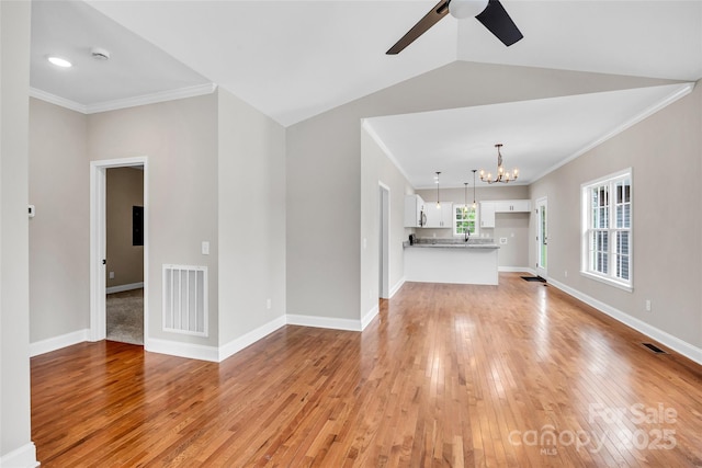 160 Wayne Gobble Rd, Linwood, NC 27299 - unfurnished living room featuring a chandelier, light wood-type flooring, ceiling fan, crown molding, and baseboards