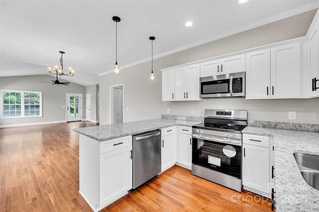 160 Wayne Gobble Rd, Linwood, NC 27299 - kitchen with stainless steel appliances, a chandelier, a peninsula, open floor plan, and white cabinetry