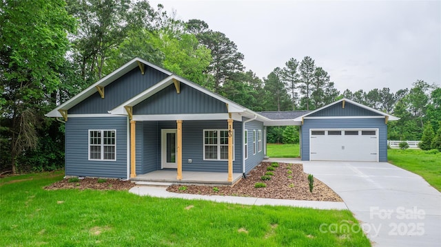 160 Wayne Gobble Rd, Linwood, NC 27299 - view of front of home featuring covered porch, a front yard, driveway, a garage, and view of scattered trees