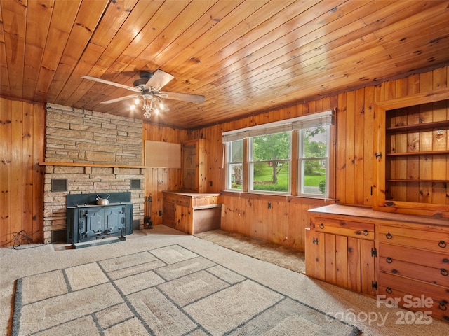 49 Caring Place Loop, Clyde, NC 28721 - unfurnished living room featuring wood walls, wood ceiling, ceiling fan, and carpet floors