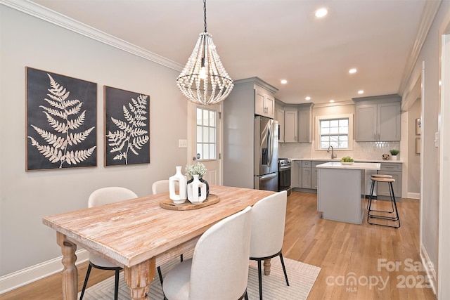 532 Scaleybark Rd, Charlotte, NC 28209 - dining space with a chandelier, ornamental molding, light wood-style flooring, recessed lighting, and baseboards
