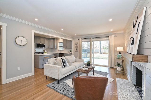 532 Scaleybark Rd, Charlotte, NC 28209 - living room with light wood-type flooring, recessed lighting, a fireplace with flush hearth, ornamental molding, and baseboards