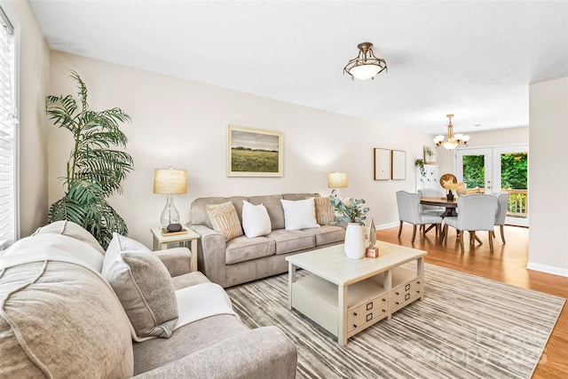 205 Davis Dr, Morganton, NC 28655 - living area with a chandelier, light wood-type flooring, and baseboards