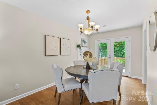 205 Davis Dr, Morganton, NC 28655 - dining space with a chandelier, light wood-style floors, baseboards, and french doors