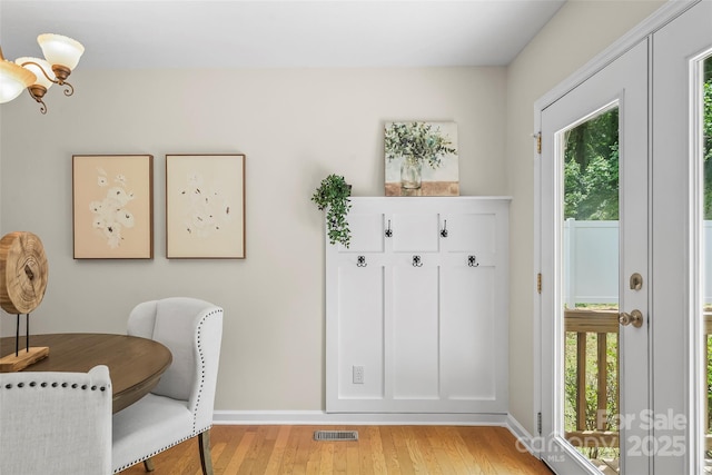 205 Davis Dr, Morganton, NC 28655 - dining space featuring light wood finished floors, plenty of natural light, a chandelier, and baseboards