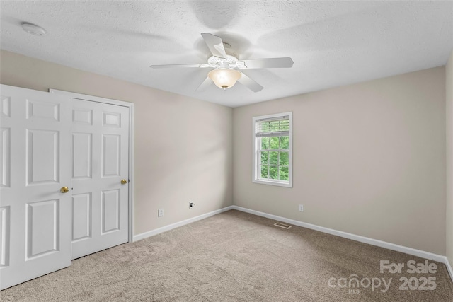 205 Davis Dr, Morganton, NC 28655 - unfurnished bedroom with carpet flooring, baseboards, a textured ceiling, and a ceiling fan