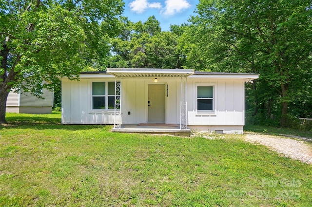 13821 David St, Huntersville, NC 28078 - view of front facade with board and batten siding, a front yard, and crawl space