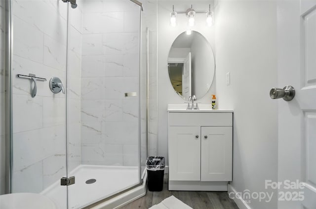 13821 David St, Huntersville, NC 28078 - full bathroom featuring a stall shower, vanity, wood finished floors, and baseboards
