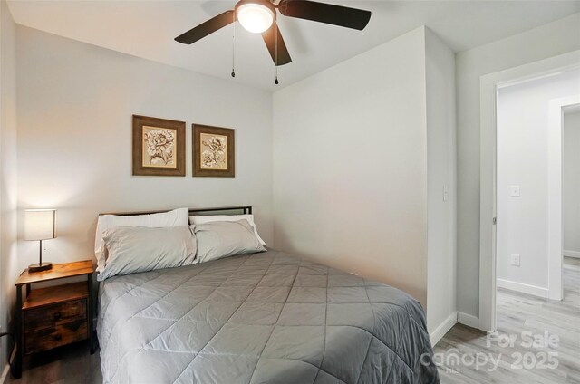 13821 David St, Huntersville, NC 28078 - bedroom featuring light wood-style floors, ceiling fan, and baseboards