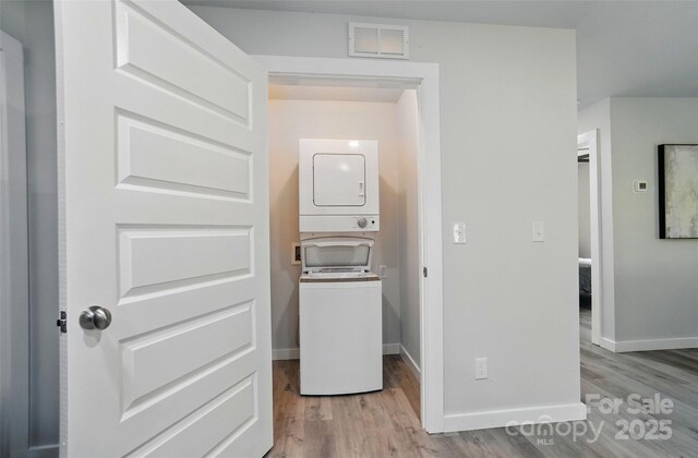 13821 David St, Huntersville, NC 28078 - laundry area featuring stacked washer / dryer, light wood finished floors, and baseboards