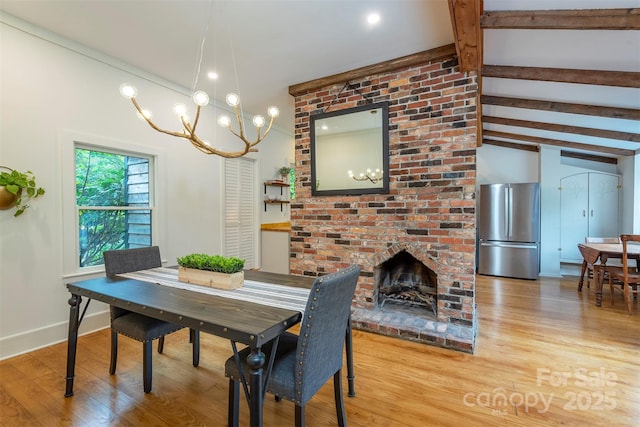 528 Padgettown Rd, Black Mountain, NC 28711 - dining area featuring wood finished floors, a chandelier, a fireplace, and baseboards