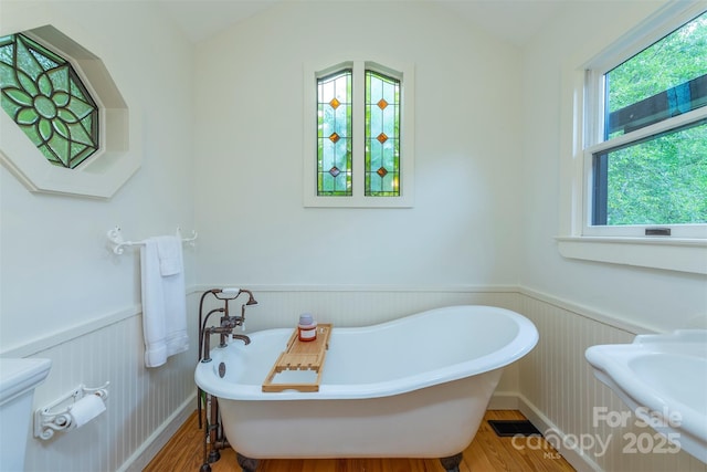 528 Padgettown Rd, Black Mountain, NC 28711 - bathroom featuring wainscoting, a freestanding bath, wood finished floors, and toilet