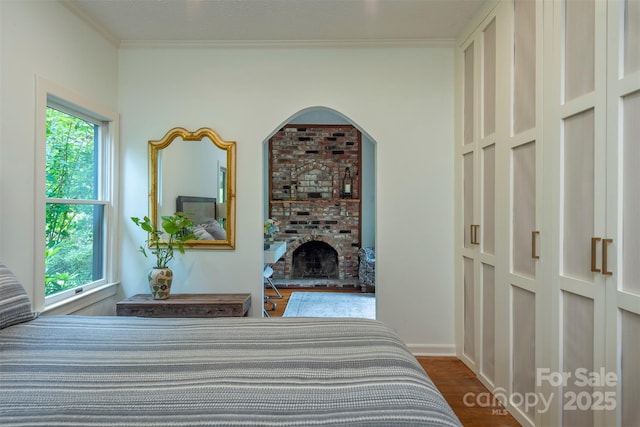 528 Padgettown Rd, Black Mountain, NC 28711 - bedroom featuring multiple windows, ornamental molding, a fireplace, and dark wood-type flooring